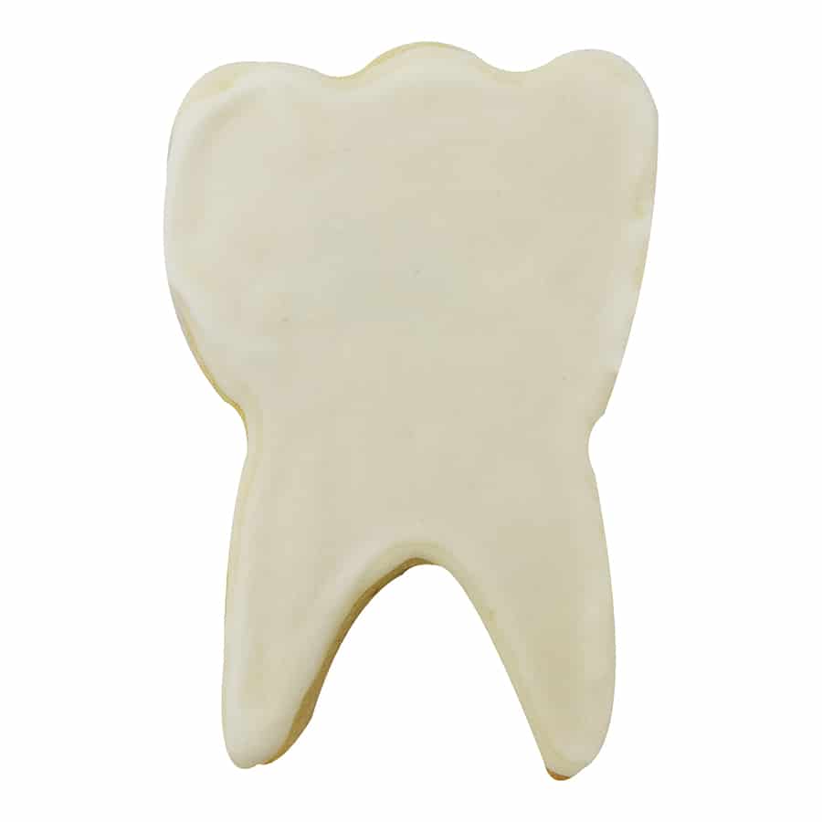 Decorated tooth-shaped cookie with smooth white icing.