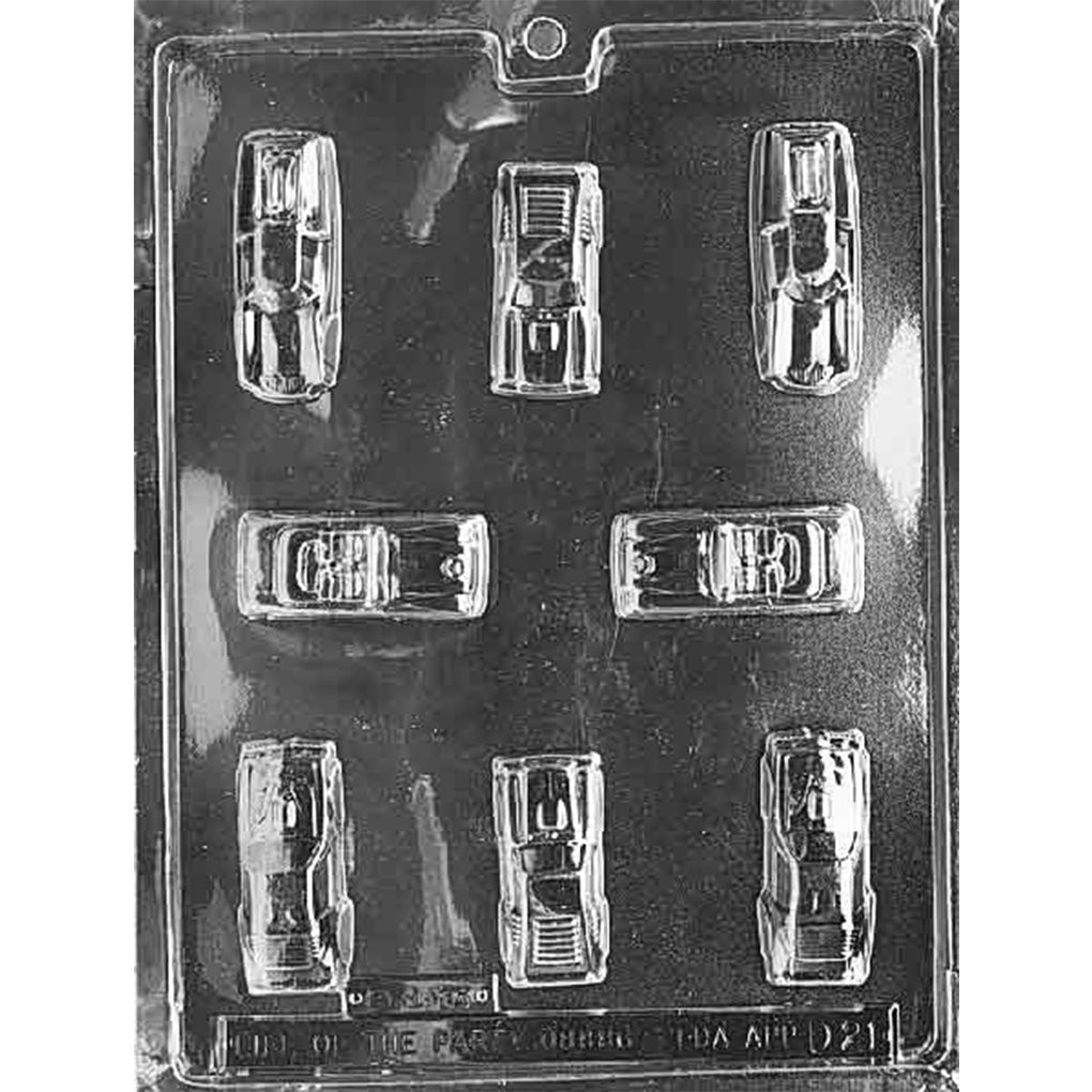 Clear plastic chocolate mold photographed against a black background, featuring multiple small toy car-shaped cavities in different angles and styles.