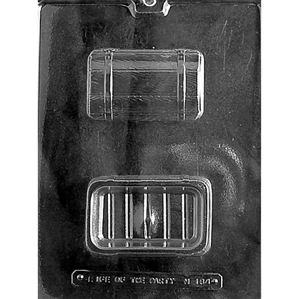 Clear plastic treasure chest pour box chocolate mold showing two cavities: a detailed chest lid with strap lines and a matching deep base cavity, on a dark background.