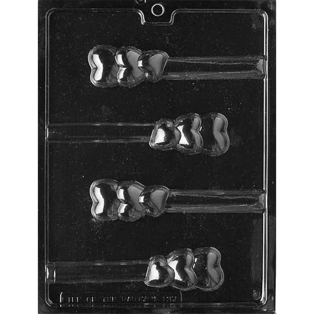 Clear plastic chocolate mold with four pretzel rod cavities, each featuring three connected heart shapes arranged vertically against a black background.