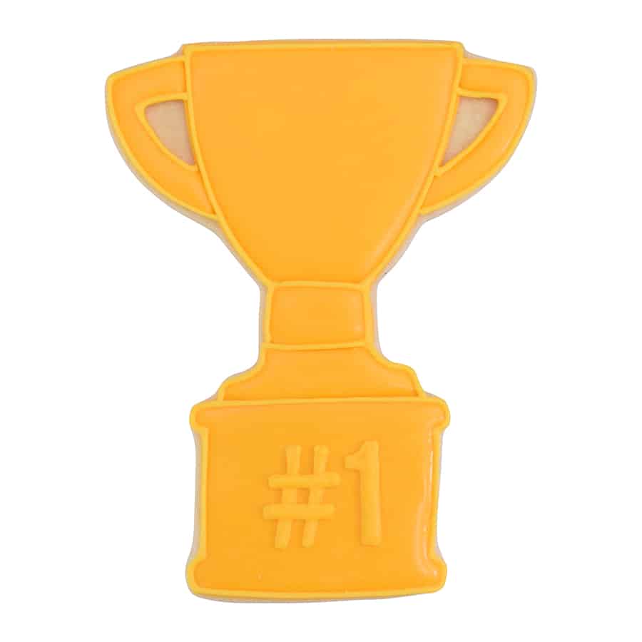 Golden trophy-shaped sugar cookie decorated with smooth yellow icing and "#1" written on the base. A fun treat for sports teams, school achievements, and celebrations.