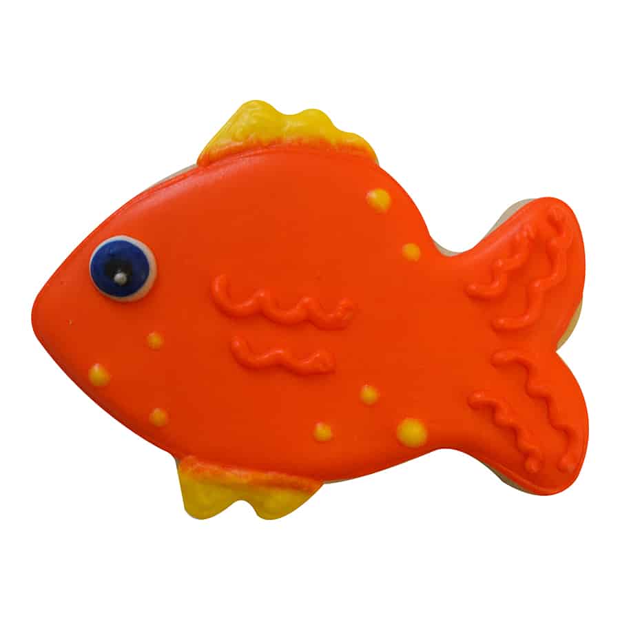 Decorated tropical fish-shaped sugar cookie with bright orange and yellow icing, featuring an eye and fin details.