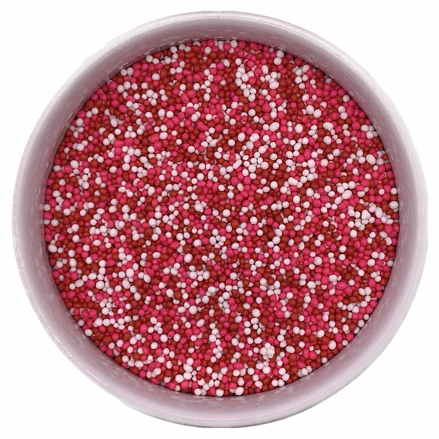 Top view of Valentine non-pareils mix featuring red, pink, and white mini sprinkles in a round container.