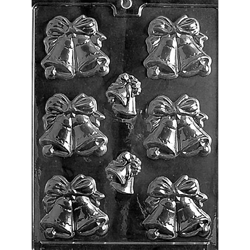 Clear plastic chocolate mold photographed on a dark background with wedding bell cavities, including multiple large double-bell shapes topped with bows and two smaller bell shapes in the center.