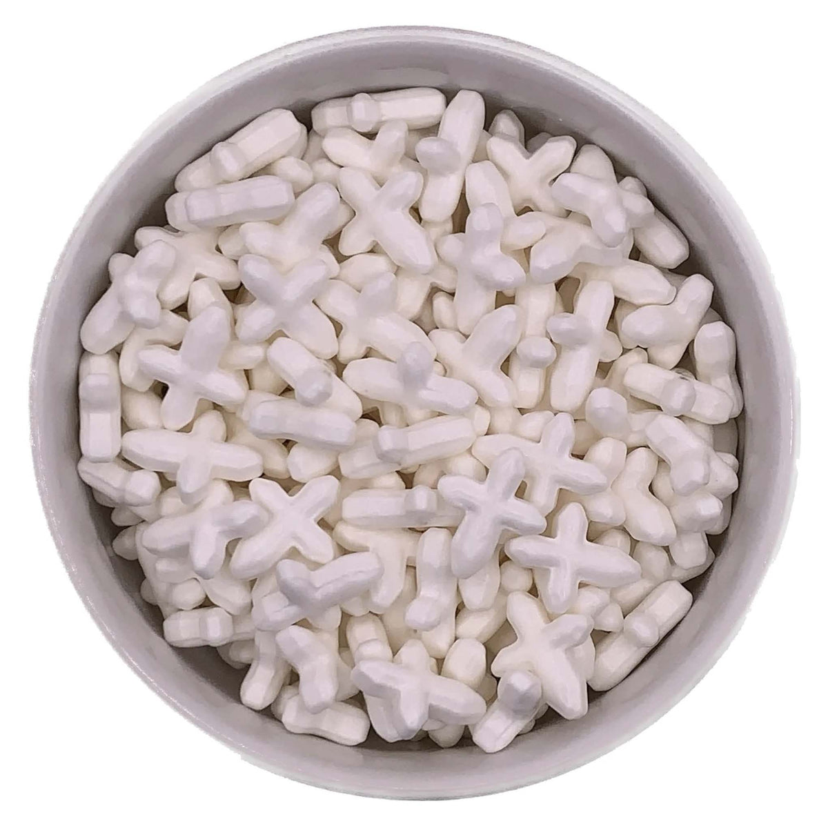 Close-up of thick white cross-shaped sprinkles, approximately 5/8 inch long, displayed in a round white bowl.