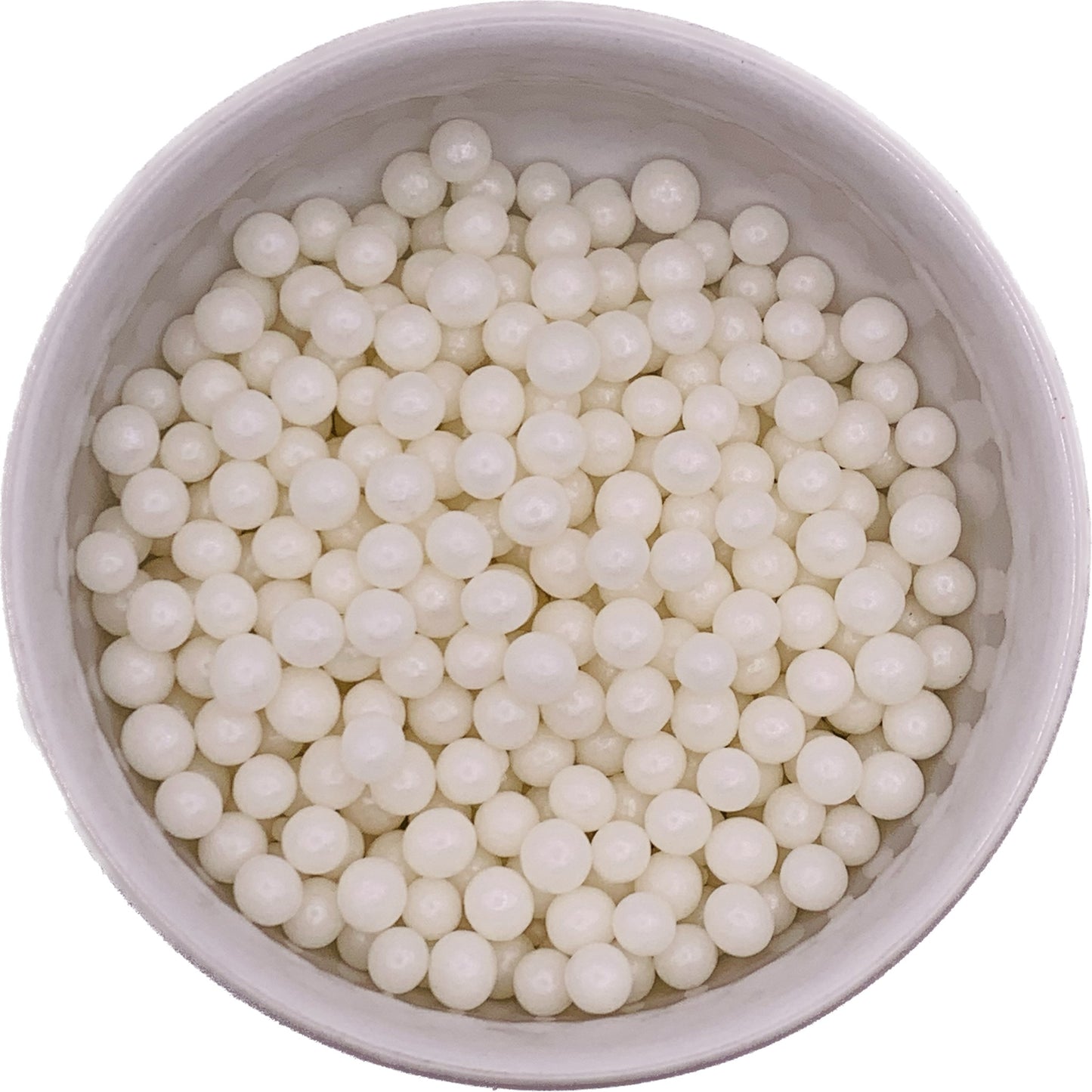 Glossy 6mm white pearl dragees in a bowl, ideal for elegant cake and cupcake decorating.