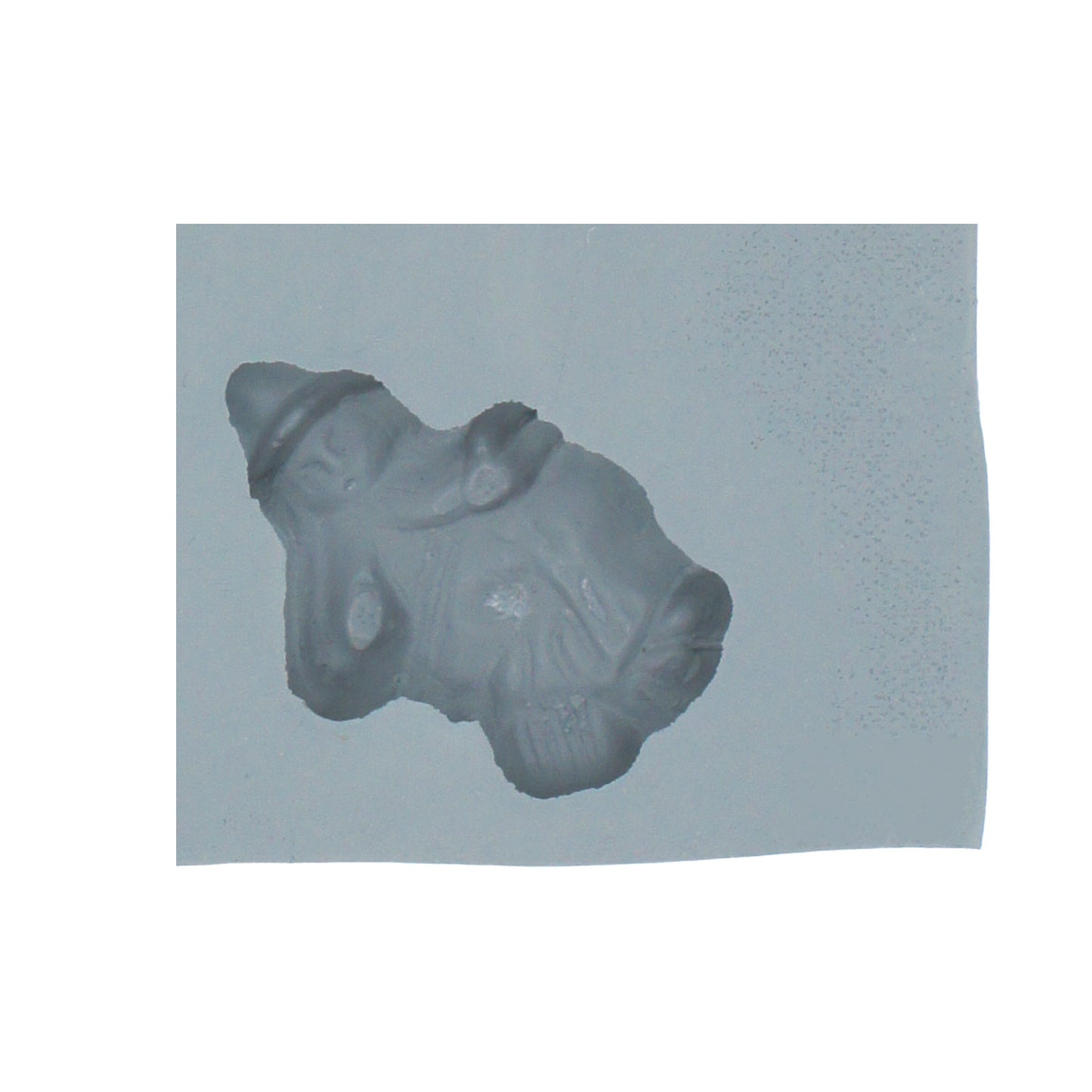 Close-up of Halloween witch-shaped rubber mint mold featuring a witch with a pointy hat and cloak.