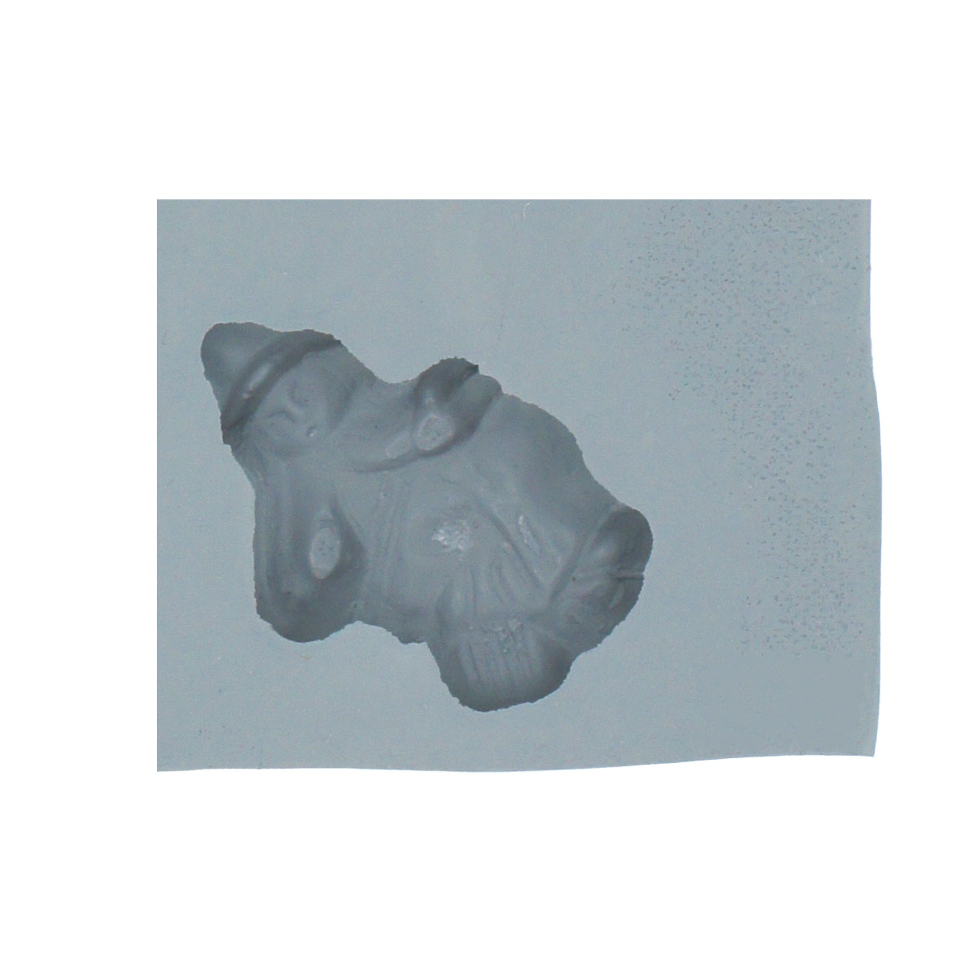 Close-up of Halloween witch-shaped rubber mint mold featuring a witch with a pointy hat and cloak.