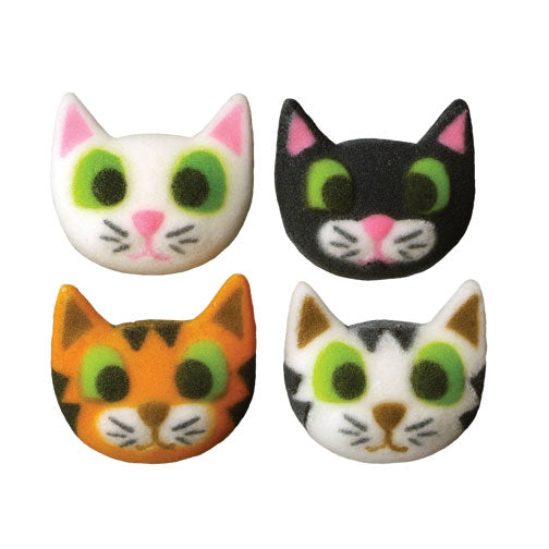 Assortment of four sugar-molded kitty edible cake decorations in orange, black, white, and mixed colors, each with playful green eyes and pink noses.