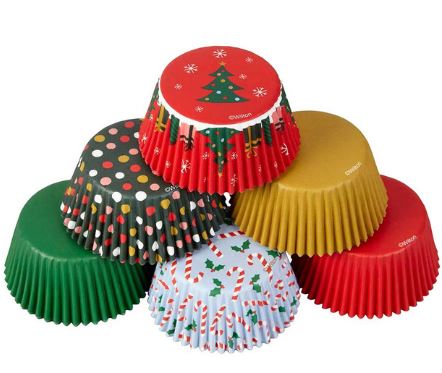 Assorted Christmas-themed cupcake liners fanned out, showcasing red, green, gold, and printed holiday patterns.