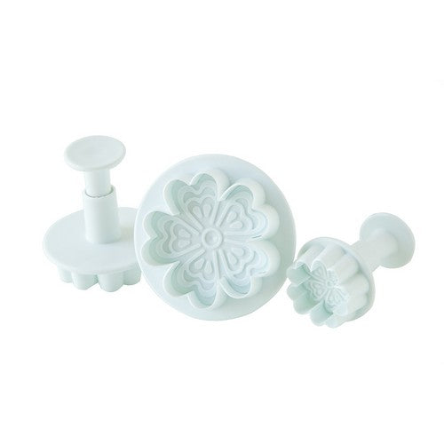 Three-piece spring flower plunger cutter set in varying sizes, designed for cutting and embossing floral shapes in fondant, cookies, or gum paste
