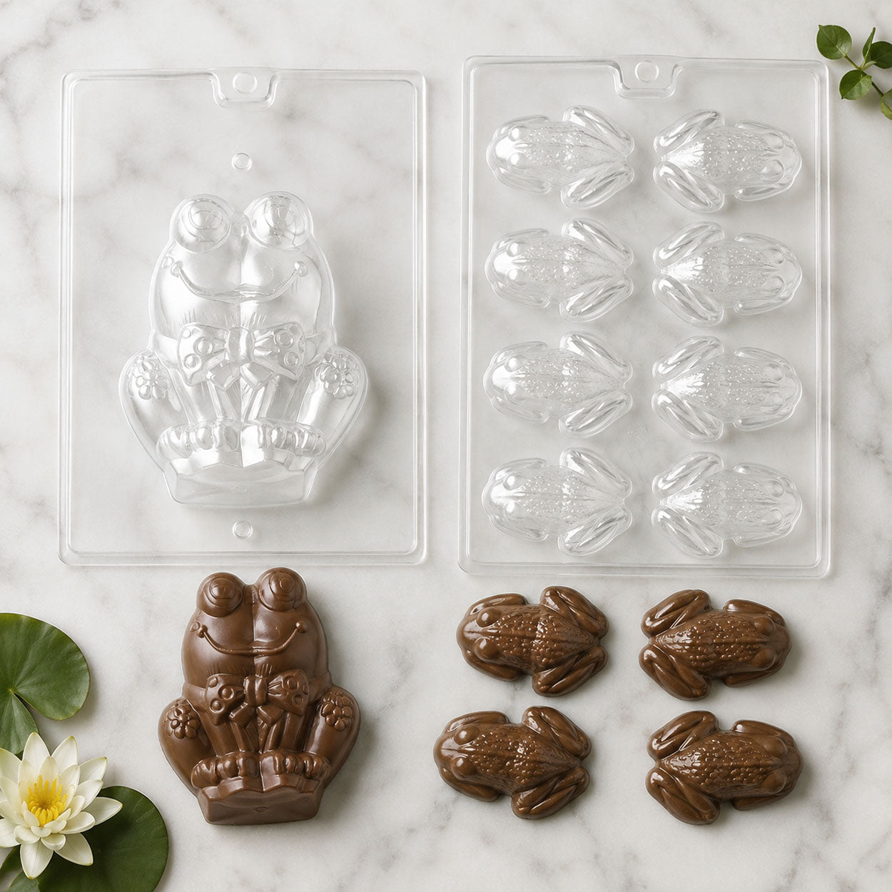 Frog chocolate molds featuring a large frog couple and small frog designs, displayed with finished milk chocolate frogs on a marble surface.