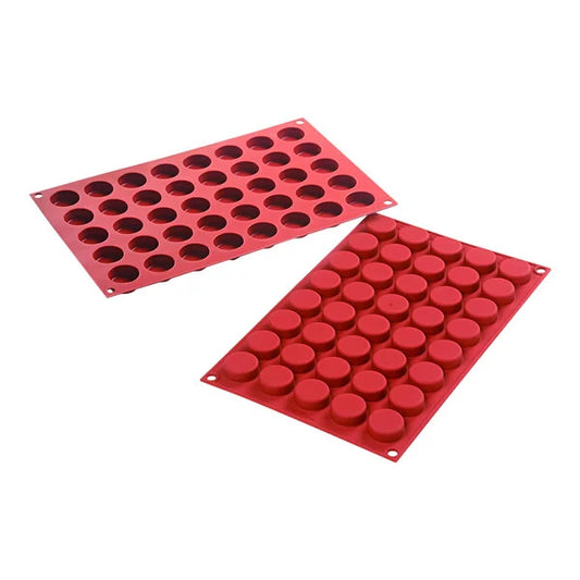 Two red Silikomart silicone molds shown at an angle, one with 40 round cavities and one showing 40 raised round forms, photographed on a white background.