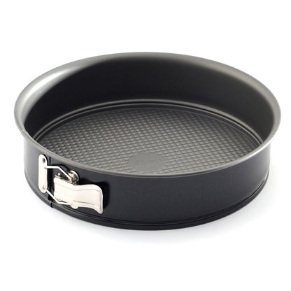 Black 10-inch nonstick springform pan with tall round sides, textured removable base, and silver spring latch photographed on a white background.