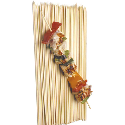Grilled chicken and vegetable kabob on a single bamboo skewer laid over a group of skewers.
