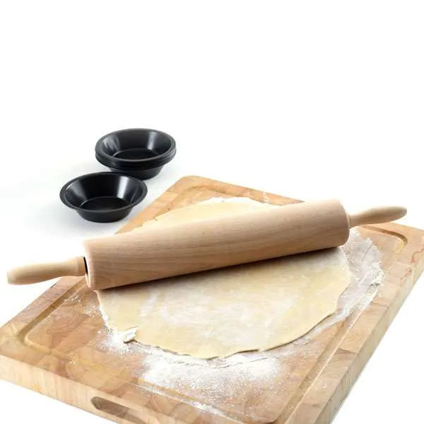 A traditional wooden rolling pin with handles, ideal for rolling out dough on a floured surface. The rolling pin is positioned on a large piece of dough, ready to be rolled out. Two small black bowls are in the background on the wooden board.