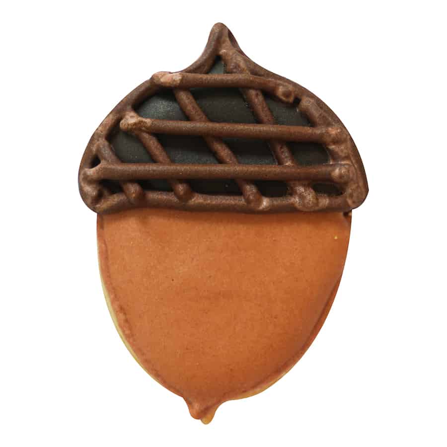 Decorated acorn-shaped cookie with brown icing for the nut, dark icing for the cap, and piped lattice details, made using the Mini Acorn Cookie Cutter.