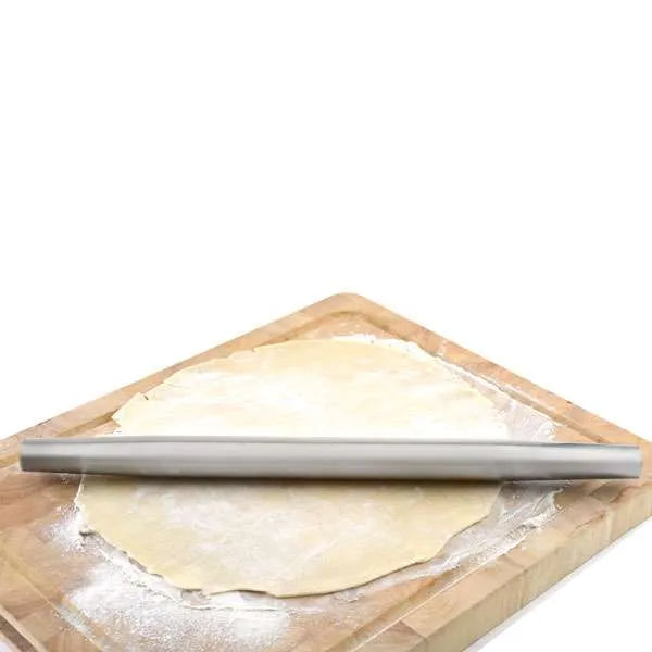 The stainless steel French rolling pin is shown in use on a floured surface, rolling out a piece of dough. The absence of handles allows for a more direct feel of the dough, making it perfect for delicate tasks.