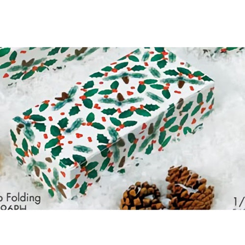 A festive 1-pound pine cone candy box with a one-piece design, decorated with a vibrant pattern of green holly leaves and red berries on a white background. The box is partially open, revealing a glimpse of the treats inside. It rests on a snowy surface alongside natural pine cones, evoking a cozy, holiday ambiance.
