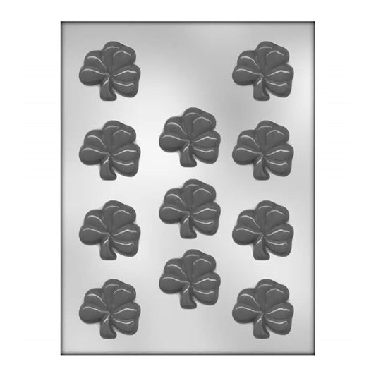 This image shows a chocolate mold designed to create eleven shamrock-shaped chocolates, with each cavity shaped like a classic three-leaf clover with well-defined leaves, each sporting a detailed central vein. The cavities are arrayed in a 4x3 grid, minus one cavity to make eleven in total. 