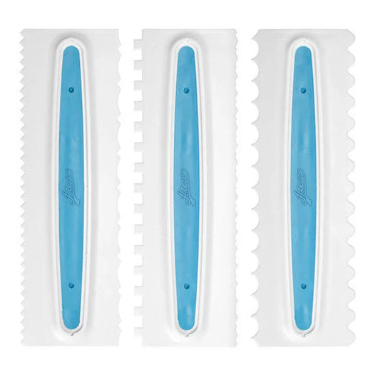 Three white icing combs with blue grip centers, each showing a different textured edge pattern for creating stripes, ridges, and waves in buttercream.