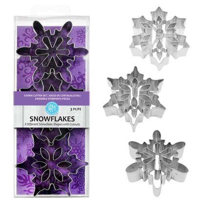 Snowflake Cookie Cutter Set with cutters arranged beside the packaging for a clear view of the different designs.