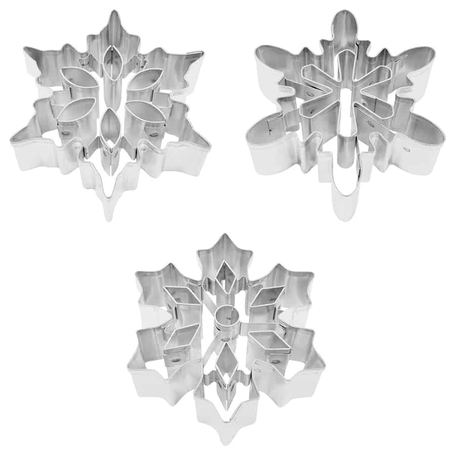 Close-up of individual snowflake cookie cutters, showcasing intricate cutout details