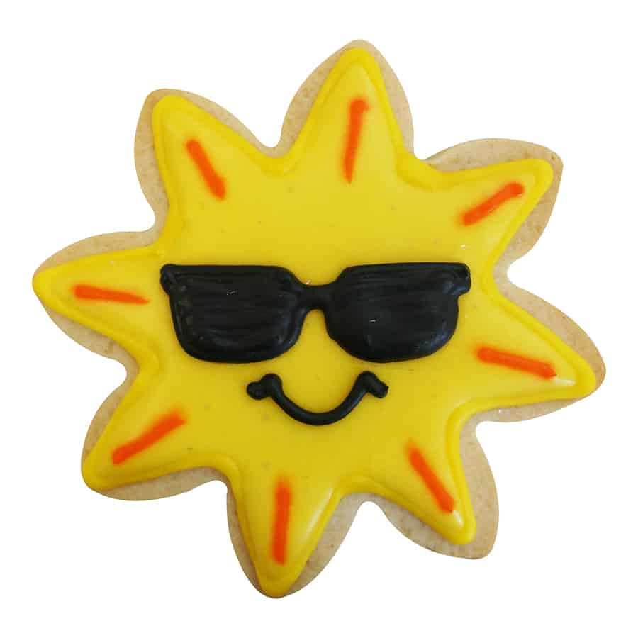 Smiling sun-shaped cookie with sunglasses and vibrant yellow icing.