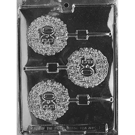 Clear 30th in Wreath Chocolate Lollipop Mold photographed against a black background with three round cavities featuring raised 30 numerals inside detailed wreath borders and stick channels.