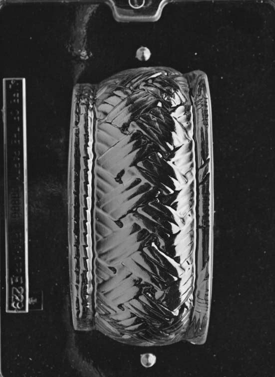 Clear plastic chocolate mold showing one half of a large round woven basket design with a deep curved cavity and textured weave pattern.