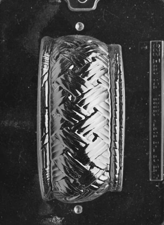 Clear plastic chocolate mold showing the matching half of a large round basket cavity with woven texture and curved sides, designed to pair for a complete 3D chocolate basket.