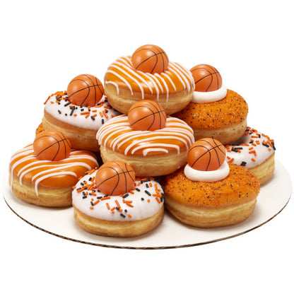 Stack of decorated donuts topped with 3D basketball rings, white and orange frosting, and themed sprinkles.