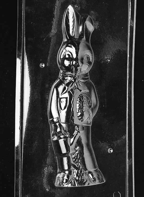 Clear plastic chocolate mold showing the front half of a tall bunny character wearing overalls and holding a small pail, with raised facial features and clothing details.