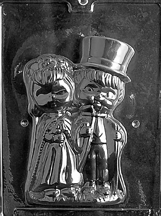 Clear plastic mold showing the front half of a 3D chocolate bride and groom figure, with detailed wedding attire including a gown, bouquet, and top hat.
