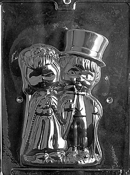 Clear plastic mold showing the front half of a 3D chocolate bride and groom figure, with detailed wedding attire including a gown, bouquet, and top hat.