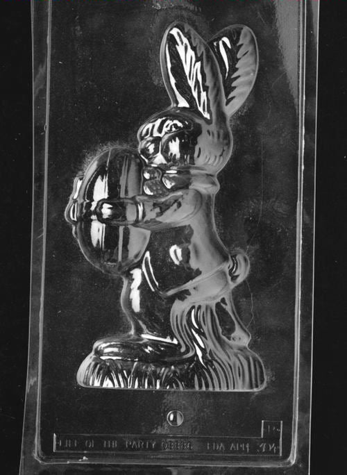 Clear plastic chocolate mold showing the matching back half of a bunny holding an egg, designed to pair with the front half to form a complete 3D chocolate figure.