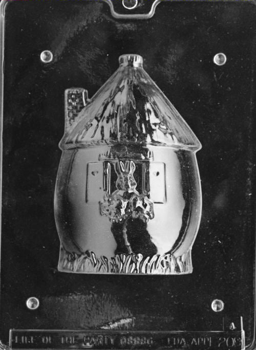 Plastic chocolate mold depicting the front of a round bunny hut with a window, chimney, and bunny figure detail.