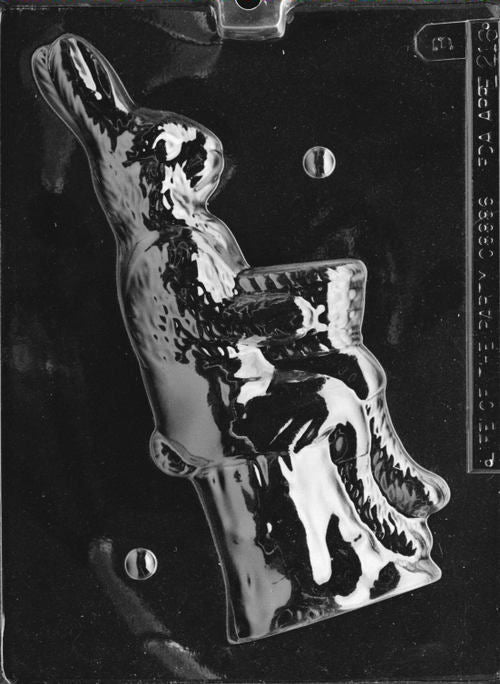 Clear plastic chocolate mold showing the matching back half of a bunny perched on a stump, designed to pair with the front half for a complete 3D figure.