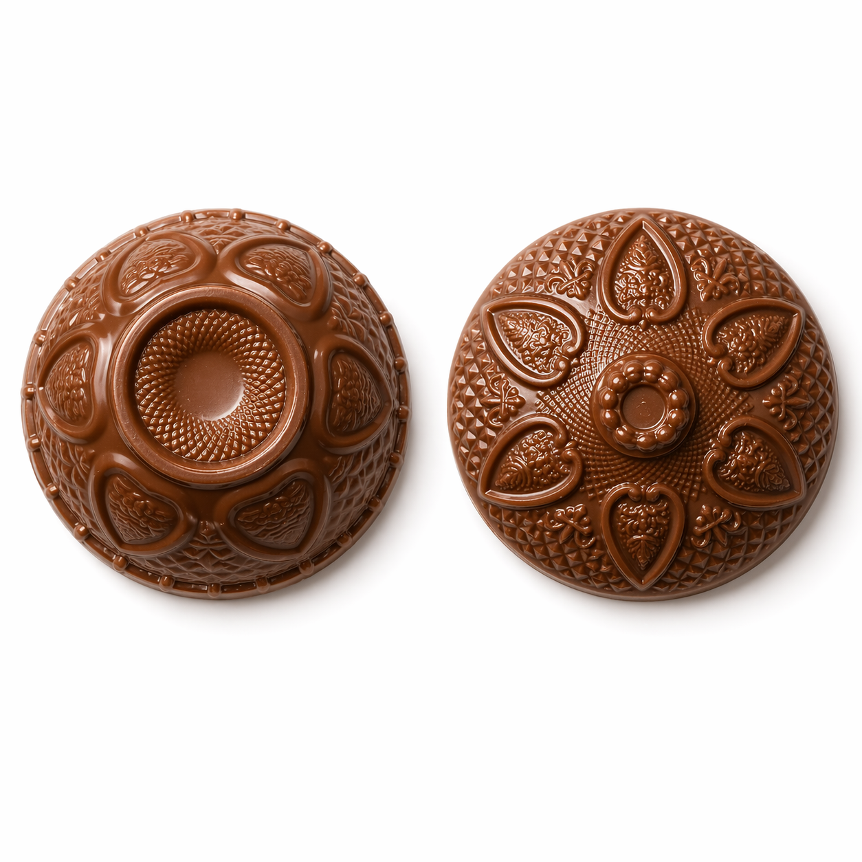 Two ornate round chocolate bowl pieces shown side by side on a white background, with one half featuring a raised circular center and textured petal-like panels, and the other half showing a detailed floral and geometric pattern with a small raised center.