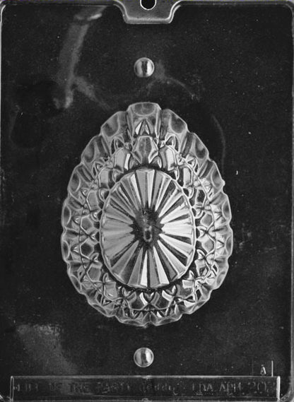 Clear plastic mold showing one half of a large faceted egg with deep geometric detailing and a crystal-cut design on the front.