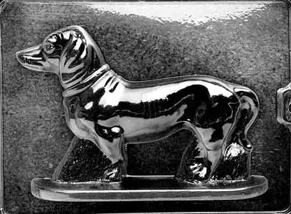 Clear plastic chocolate mold showing the matching back half of a dachshund with tail and haunch contours, designed to pair with the front half for a complete 3D chocolate figure.