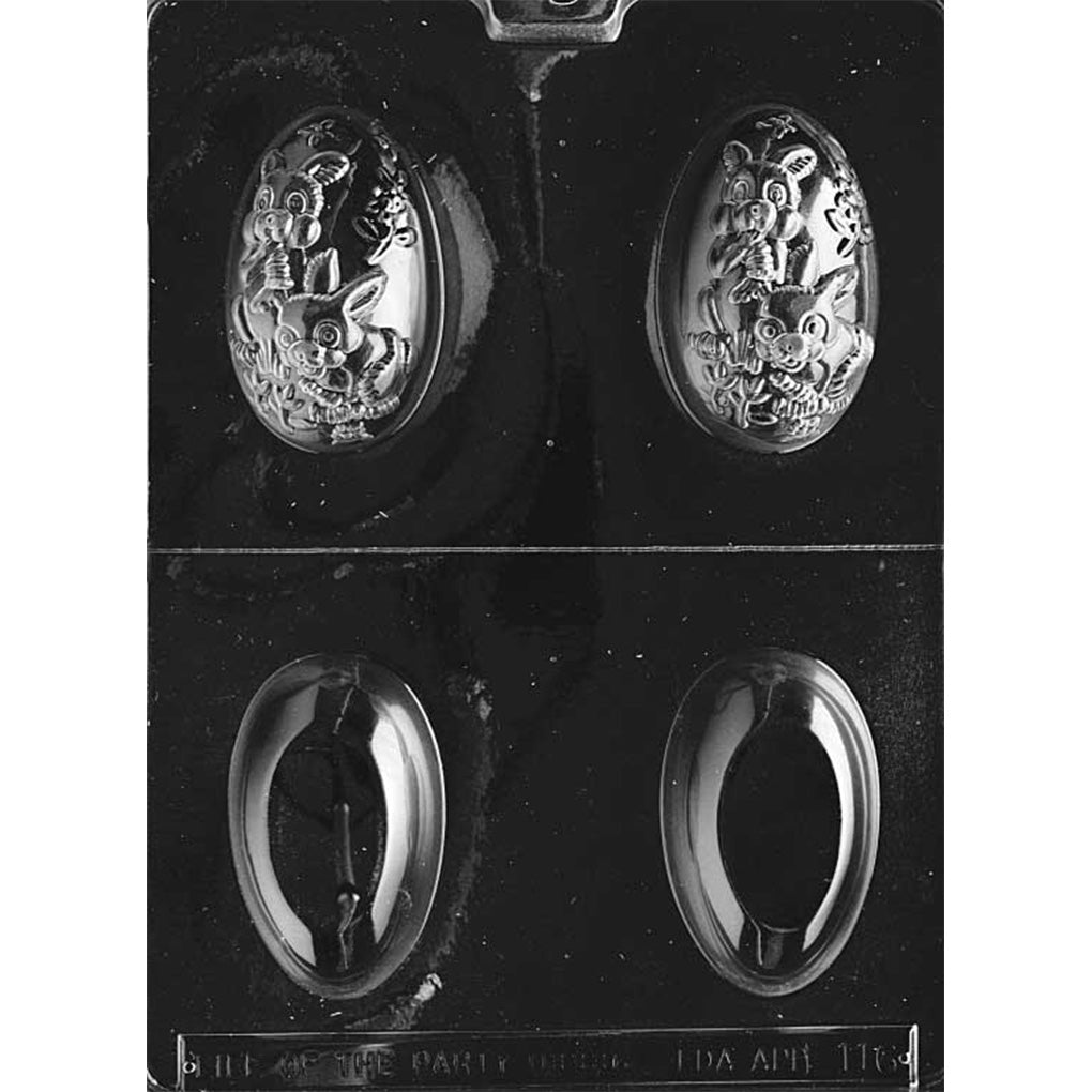 Clear plastic 3D Easter egg chocolate mold sheet with four egg cavities split by a center line, showing two detailed eggs with bunnies and flowers and two smooth egg halves for forming a complete 3D egg.