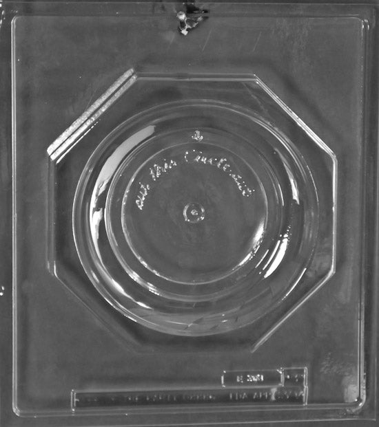 Clear plastic chocolate mold showing the matching backing piece for an octagonal chocolate plate, with a smooth circular center and recessed border for assembling a finished plate.