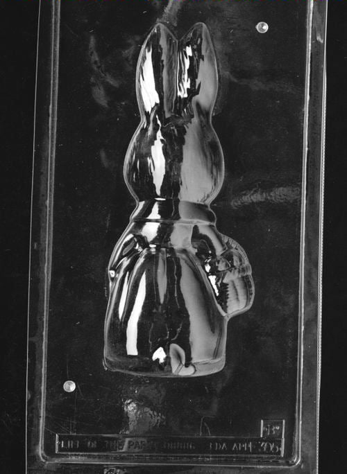 Clear plastic chocolate mold showing the matching back half of a girl bunny figure with rounded contours and the basket shape continuing at the side, designed to pair for a 3D chocolate.