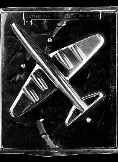 Clear plastic chocolate mold showing the matching half of a large jet plane with wing panel details and raised engine shapes, made to pair for a complete 3D chocolate airplane.