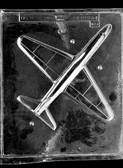 Clear plastic chocolate mold showing one half of a large jet airplane with wide wings and a streamlined fuselage, designed for a 3D chocolate plane.