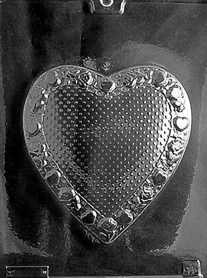 Clear plastic mold showing a large heart shape with textured surface and a decorative border of raised hearts, designed as the lid of a chocolate pour box.