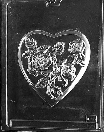 Clear plastic chocolate mold with a heart shape embossed with a detailed rose bouquet and leaves, designed for use as the lid of a chocolate pour box.