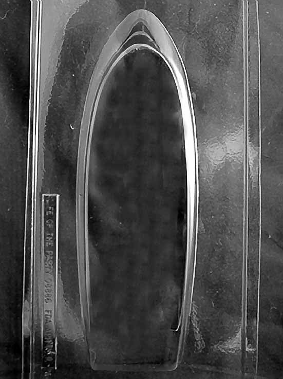 Clear plastic chocolate mold with a large yacht-shaped cavity, featuring a long tapered hull silhouette for a large 3D-style chocolate boat showpiece.