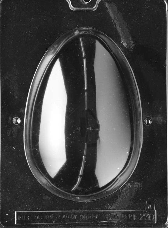 Clear plastic chocolate mold showing the matching back half of a large smooth egg cavity, designed to pair with the lily-decorated front for a complete 3D chocolate egg.